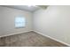 Cozy carpeted bedroom offers neutral tones and a window for natural light at 3735 Boulder Park Sw Dr, Atlanta, GA 30331
