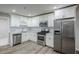 Bright kitchen featuring stainless steel appliances, white cabinets, and stylish subway tile backsplash at 3735 Boulder Park Sw Dr, Atlanta, GA 30331