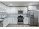 Well-equipped kitchen featuring stainless steel appliances, white cabinets, and subway tile backsplash at 3735 Boulder Park Sw Dr, Atlanta, GA 30331