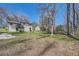 Spacious backyard with a two-story home, a deck, and lush greenery, creating a private retreat at 6552 King George Way, Morrow, GA 30260