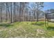 Expansive backyard with mature trees, green grass, and a shed, ideal for outdoor activities and relaxation at 6552 King George Way, Morrow, GA 30260