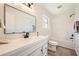 Bright bathroom with a single vanity, large mirror, and shower and tub combination at 6552 King George Way, Morrow, GA 30260