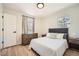 Bright bedroom featuring modern furnishings, a cozy bed, and natural light streaming through the windows at 6552 King George Way, Morrow, GA 30260