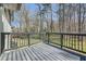 Deck overlooking a private backyard surrounded by mature trees at 6552 King George Way, Morrow, GA 30260