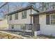 Stunning exterior showcasing a well-maintained front porch with stylish black shutters and landscaping at 6552 King George Way, Morrow, GA 30260