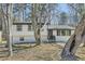 Charming home featuring mature trees, a brick facade, and a welcoming front porch at 6552 King George Way, Morrow, GA 30260