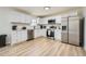 Modern kitchen with stainless steel appliances, white cabinets, and light-colored countertops at 6552 King George Way, Morrow, GA 30260