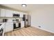 Charming kitchen with stainless steel appliances, white cabinets, and light-colored countertops at 6552 King George Way, Morrow, GA 30260