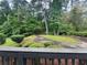 Lush backyard view from the deck, showcasing manicured greenery and mature trees at 765 Corundum Ct, Stone Mountain, GA 30083
