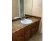 Bathroom vanity with a cultured marble top, a chrome faucet, and dark wood cabinetry at 765 Corundum Ct, Stone Mountain, GA 30083