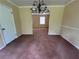 Cozy dining room with a classic chandelier and wall to wall carpet, leading to an adjacent room at 765 Corundum Ct, Stone Mountain, GA 30083