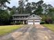 Charming two-story home with a two-car garage and a well-maintained front yard, nestled among mature trees at 765 Corundum Ct, Stone Mountain, GA 30083