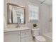 Modern bathroom featuring a white vanity, marble accents, and a bathtub at 874 Welch St, Atlanta, GA 30310