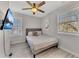 Cozy bedroom features a ceiling fan, neutral paint, and a window letting in natural light at 874 Welch St, Atlanta, GA 30310