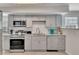 Well-equipped kitchen with stainless steel appliances, gray cabinets, and granite countertops at 874 Welch St, Atlanta, GA 30310
