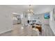 Open-concept living room with stylish decor, vinyl flooring, and a view of the kitchen at 874 Welch St, Atlanta, GA 30310