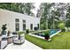 Backyard features a modern pool, turf lawn, and patio space perfect for outdoor entertainment and relaxation at 1572 Clifton Rdg, Atlanta, GA 30307