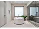 Modern bathroom featuring a freestanding tub, a walk-in shower, and a large window for natural light at 1572 Clifton Rdg, Atlanta, GA 30307