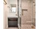 Modern bathroom features a walk-in shower, gray vanity, and gold hardware adding a luxurious touch at 1572 Clifton Rdg, Atlanta, GA 30307