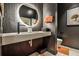 Stylish half bathroom featuring a modern vessel sink, unique wood-paneled walls, and elegant black fixtures at 1572 Clifton Rdg, Atlanta, GA 30307