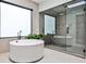 Modern bathroom featuring a freestanding tub, a walk-in shower with glass door, and sleek fixtures at 1572 Clifton Rdg, Atlanta, GA 30307