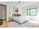 Spacious bedroom with modern design, light hardwood floors, and a window with a green view at 1572 Clifton Rdg, Atlanta, GA 30307