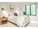 Serene bedroom with a plush bed, soft lighting, and a large window offering peaceful outdoor views at 1572 Clifton Rdg, Atlanta, GA 30307