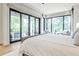 Primary bedroom with large windows overlooking a backyard patio and lush greenery at 1572 Clifton Rdg, Atlanta, GA 30307