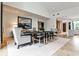 Bright dining area boasts a large modern table, stylish chairs, and expansive windows for natural light at 1572 Clifton Rdg, Atlanta, GA 30307
