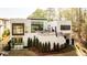 Striking exterior of a modern home with expansive windows, a terrace and landscaped grounds, backing onto mature trees at 1572 Clifton Rdg, Atlanta, GA 30307