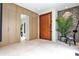 Bright foyer with custom millwork, accent wall, large format tile flooring and wood door at 1572 Clifton Rdg, Atlanta, GA 30307