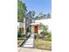 Inviting front entrance with stone accents and modern pathway leading to the natural wood door at 1572 Clifton Rdg, Atlanta, GA 30307