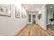 Bright hallway with wood floors, white walls, modern art, and recessed lighting for a clean, contemporary aesthetic at 1572 Clifton Rdg, Atlanta, GA 30307
