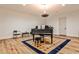 Open living room features a grand piano, hardwood floors, and neutral colors for a refined, welcoming ambiance at 1572 Clifton Rdg, Atlanta, GA 30307