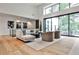 Bright, modern living room with high ceilings, a neutral palette, and floor to ceiling windows overlooking the backyard at 1572 Clifton Rdg, Atlanta, GA 30307