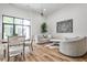 Bright open-concept living room with hardwood floors, modern furnishings, and a large window for natural light at 1572 Clifton Rdg, Atlanta, GA 30307
