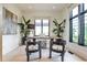Stylish home office featuring a rustic desk, accent chairs, and natural light from multiple windows at 1572 Clifton Rdg, Atlanta, GA 30307