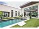 Stunning modern home showcasing a backyard oasis with a pristine pool, lush turf, and an inviting outdoor living space at 1572 Clifton Rdg, Atlanta, GA 30307