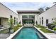 Serene backyard featuring a lap pool with a built in bench, a manicured lawn, and contemporary architectural design at 1572 Clifton Rdg, Atlanta, GA 30307