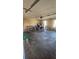 Large garage featuring concrete flooring, two windows and fluorescent lighting at 2860 Camelot Woods Dr, Lawrenceville, GA 30044