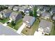 Aerial shot of a neighborhood showcasing well-maintained lawns, houses, and tree-lined streets at 4071 Woodward Walk Ln, Suwanee, GA 30024