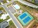 Aerial view featuring the community pool, playground, tennis courts, and well-maintained landscaping at 4071 Woodward Walk Ln, Suwanee, GA 30024