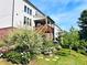 Exterior view of the house featuring a wooden deck, well-maintained garden, and a green lawn at 4071 Woodward Walk Ln, Suwanee, GA 30024