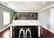 Custom wet bar featuring tile backsplash, ample cabinetry, and countertop seating for entertaining at 4071 Woodward Walk Ln, Suwanee, GA 30024