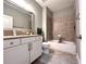 Neutral bathroom featuring tiled shower over bath, large mirror, and vanity with storage at 4071 Woodward Walk Ln, Suwanee, GA 30024