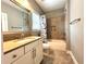 Tidy bathroom featuring a tub and shower combo, single vanity, and neutral tiling, offering a clean and functional design at 4071 Woodward Walk Ln, Suwanee, GA 30024