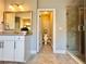 Well-appointed bathroom with white cabinets, granite counters, glass shower and adjacent toilet room at 4071 Woodward Walk Ln, Suwanee, GA 30024