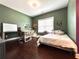 Bright bedroom features desk area, window, and a comfortable bed, perfect for work and relaxation at 4071 Woodward Walk Ln, Suwanee, GA 30024