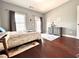 Bright bedroom with a neutral color scheme, features a full size bed, a dresser and a window at 4071 Woodward Walk Ln, Suwanee, GA 30024