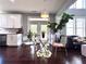 Dining area features a glass-topped table, modern chairs, a leafy potted plant, and access to the kitchen at 4071 Woodward Walk Ln, Suwanee, GA 30024